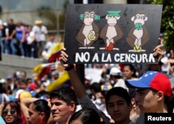 FILE - An opposition supporter holds a placard which reads "No to censorship" during a protest against President Nicolas Maduro's government in Caracas, Feb. 16, 2014.