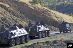 FILE - Turkish soldiers in armored vehicles patrol in Sirnak province on the Turkish-Iraqi border, October 21, 2011.
