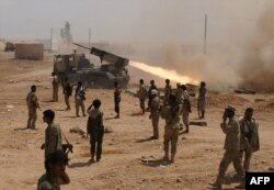 FILE - Yemeni soldiers stand near a rocket launching during a major offensive against al-Qaida in the Arabian Peninsula (AQAP) in the Maifaa region of Shabwa province, May 4, 2014.