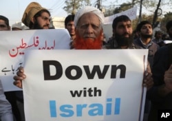 Supporters of a Pakistani religious party rally against the United States and Israel, in Lahore, Pakistan, Dec. 7, 2017.