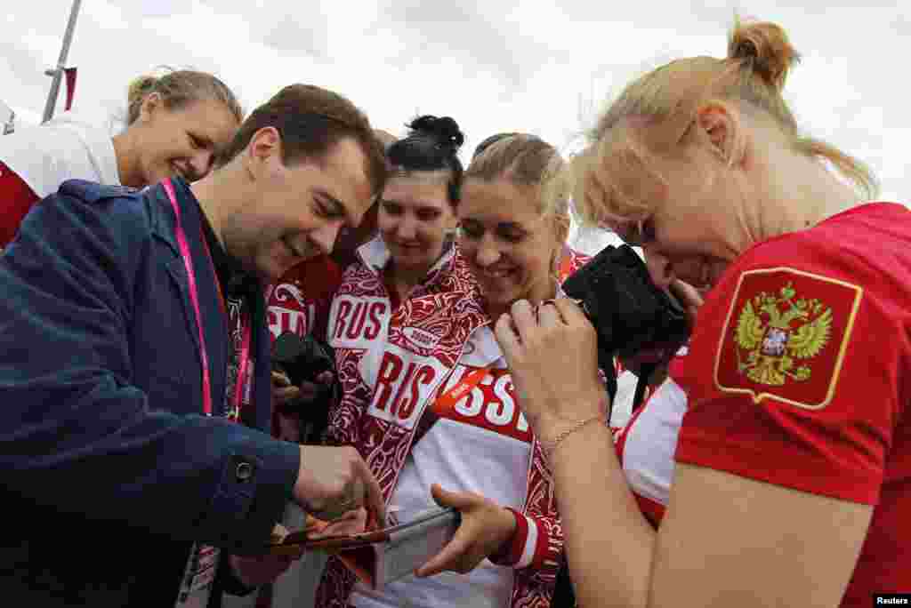 Russia's Prime Minister Dmitry Medvedev (L) meets with members of the Russian Olympic team as he visits the Olympic Village at the London 2012 Olympic Games in London July 28, 2012.