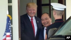 President Donald Trump walks Vietnamese Prime Minister Nguyen Xuan Phuc to his car following their meeting at the White House in Washington, May 31, 2017.