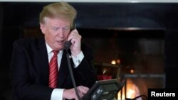 FILE - U.S. President Donald Trump conducts a phone call at the White House, in Washington, Dec. 24, 2018.