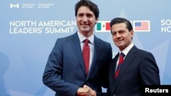 FILE - Canada's Prime Minister Justin Trudeau (left) greets Mexico's President Enrique Pena Nieto as he arrives for the North American Leaders' Summit in Ottawa, Ontario, Canada, June 29, 2016. 