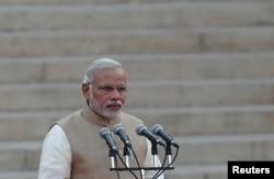 India's Prime Minister Narendra Modi takes his oath at the presidential palace in New Delhi May 26, 2014