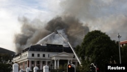 SAFRICA-PARLIAMENT/FIREaFirefighters work at the national parliament as the fire flared up again, in Cape Town, South Africa, January 3, 2022. REUTERS/Mike Hutchings