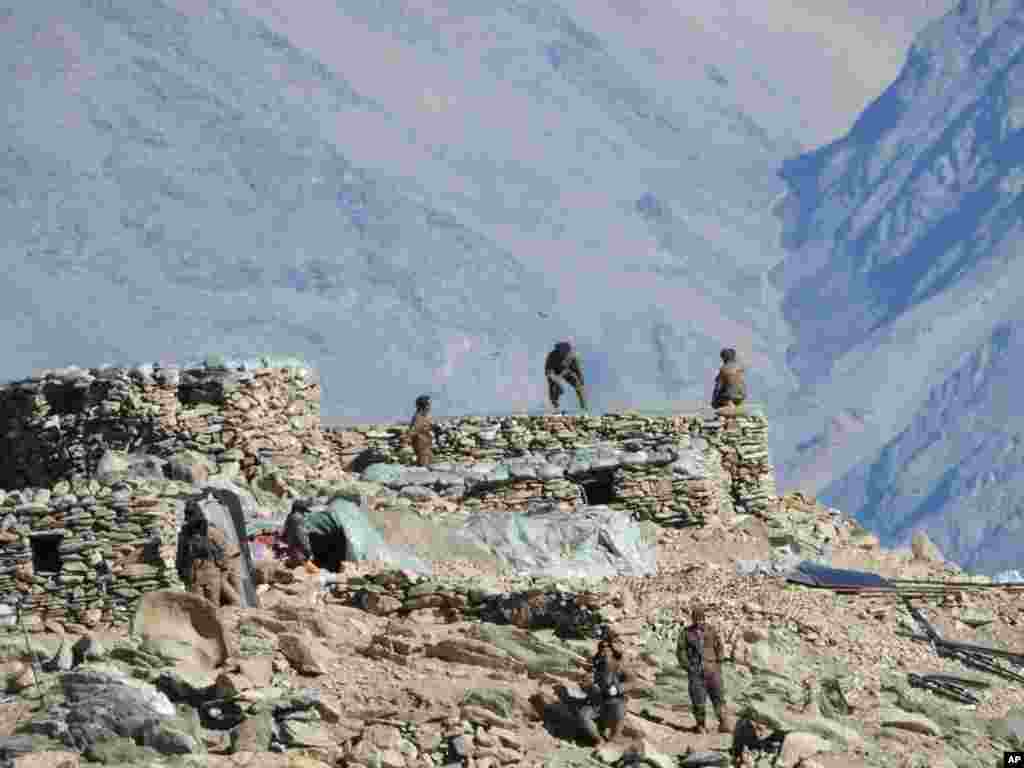 This photograph provided by the Indian Army, shows Chinese troops dismantling their bunkers at Pangong Tso region, in Ladakh along the India-China border, Feb.15, 2021.