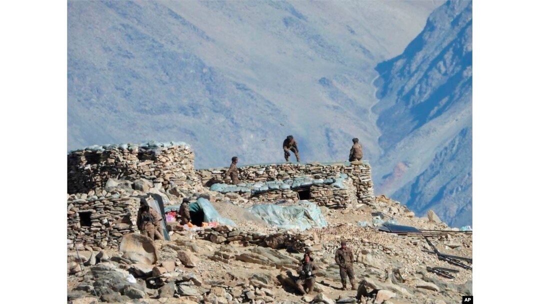 FILE - This photograph provided by the Indian Army, according to them shows Chinese troops dismantling their bunkers at Pangong Tso region, in Ladakh along the India-China border, Feb.15, 2021.