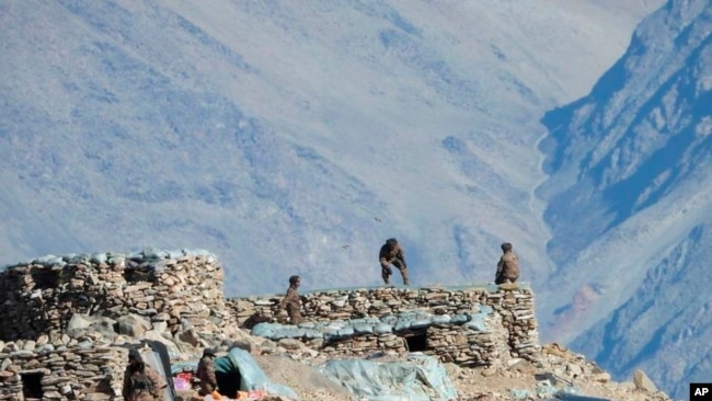 FILE - This photograph provided by the Indian Army, according to them shows Chinese troops dismantling their bunkers at Pangong Tso region, in Ladakh along the India-China border on Monday, Feb.15, 2021.