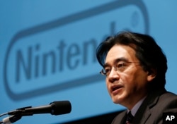 FILE - In this Jan. 31, 2013 file photo, Nintendo Co. President Satoru Iwata speaks during a news conference in Tokyo.