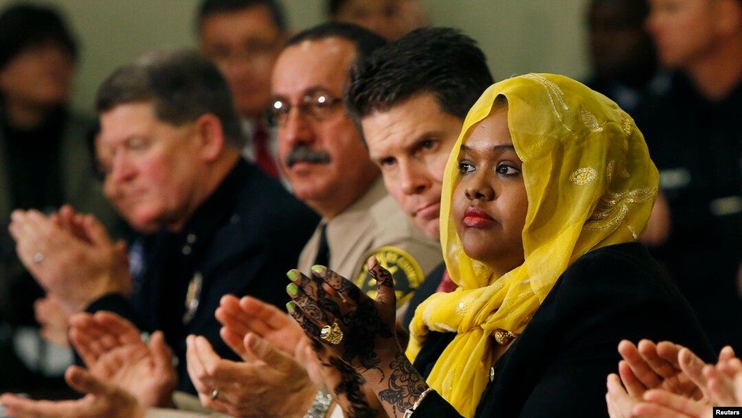 FILE - Deeqo Jibril (right) applauds United States Vice President Joe Biden after Biden's opening remarks at a roundtable on countering violent extremism at the White House in Washington, Feb. 17, 2015.