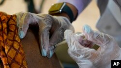 FILE - In this Jan. 12, 2021, photo, a resident of Harmony Court Assisted Living receives the Pfizer COVID-19 vaccine in Jackson, Miss.