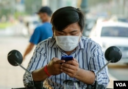 FILE - A man uses his mobile phone in Phnom Penh, on March 10, 2021. (Hean Socheata/VOA Khmer)