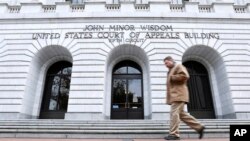 FILE - A man walks in front of the 5th U.S. Circuit Court of Appeals in New Orleans, Jan. 7, 2015.