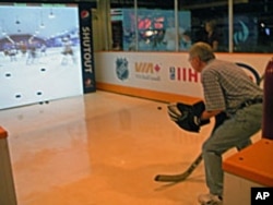 A visitor tries this state-of-the-art interactive exhibit where he is in the net and trying to stop simulated shots from NHL legends like Wayne Gretzky and Mark Messier