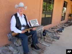 In this Tuesday, March 15, 2016 photo, Jim Chilton poses for a photo on the front porch of his home on his 50,000 acre ranch along the U.S-Mexico border in Arivaca, Arizona.