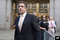 FILE - Michael Cohen leaves Federal court in New York, Aug. 21, 2018.