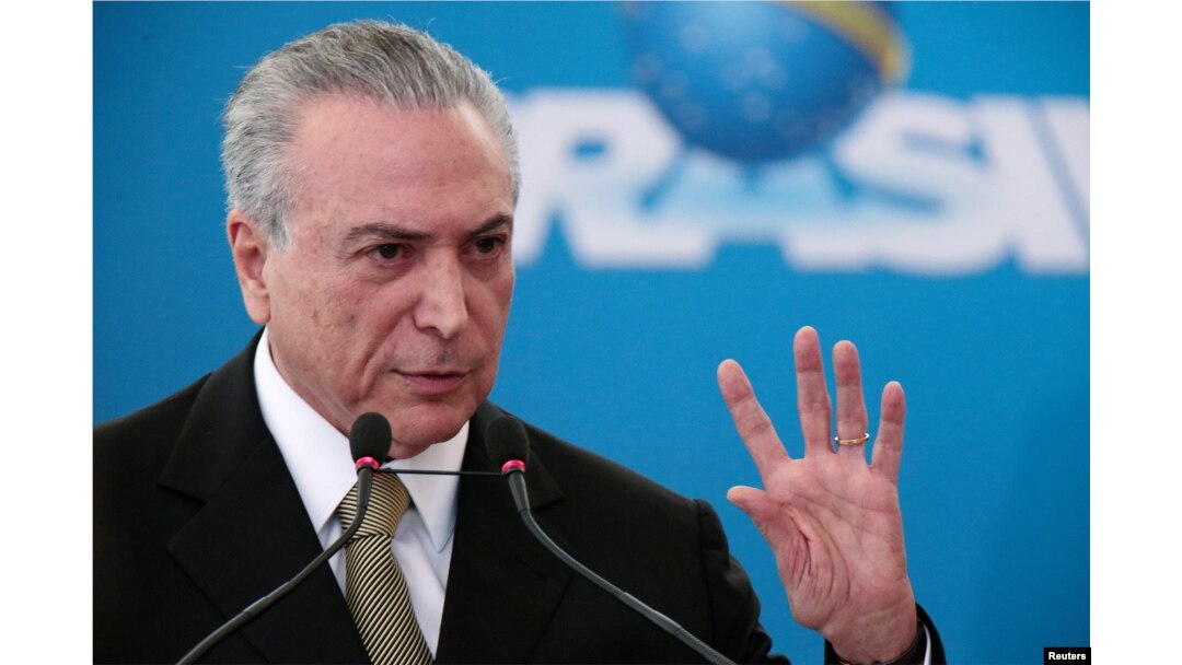 Brazil's interim President Michel Temer gestures during the inauguration ceremony of new presidents of state companies, at the Planalto Palace in Brasilia, June 1, 2016.