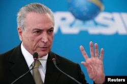 Brazil's interim President Michel Temer gestures during the inauguration ceremony of new presidents of state companies, at the Planalto Palace in Brasilia, June 1, 2016.