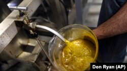 CBD oil flows into a large container during the extraction process from hemp plants at New Earth Biosciences in Salem, Oregon. Taken April 25, 2018