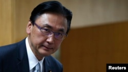 FILE- Japan's Minister-in-Charge of the Abduction Issue and head of the national public safety commission Keiji Furuya arrives at a meeting with the family members of victims kidnapped by North Korea, in Tokyo May 30, 2014. 