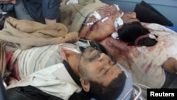 23일 키루쿠크 하위자에서 발생한 군과 시위대의 충돌로 부상당한 남성 2명이 병원에 누워있다.