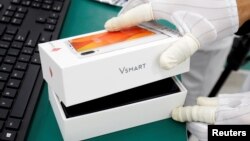 A manufacturer works at an assembly line of Vingroup's Vsmart phone in Hai Phong, Vietnam, Dec. 4, 2018.