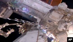This still image taken from live video provided by NASA shows astronaut Shane Kimbrough, right, working on the International Space Station during a space walk, March 24, 2017.