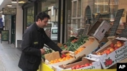 Andreas Georghiou arranges produce for the People's Supermarket in London