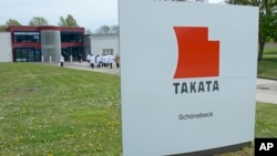 FILE - Journalists visit the production of pyro-electric airbag initiators at the international automotive supplier Takata Ignition Systems GmbH in Schoenebeck, Germany.