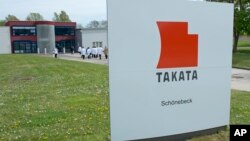 FILE - Journalists visit the production of pyro-electric airbag initiators at the international automotive supplier Takata Ignition Systems GmbH in Schoenebeck, Germany.
