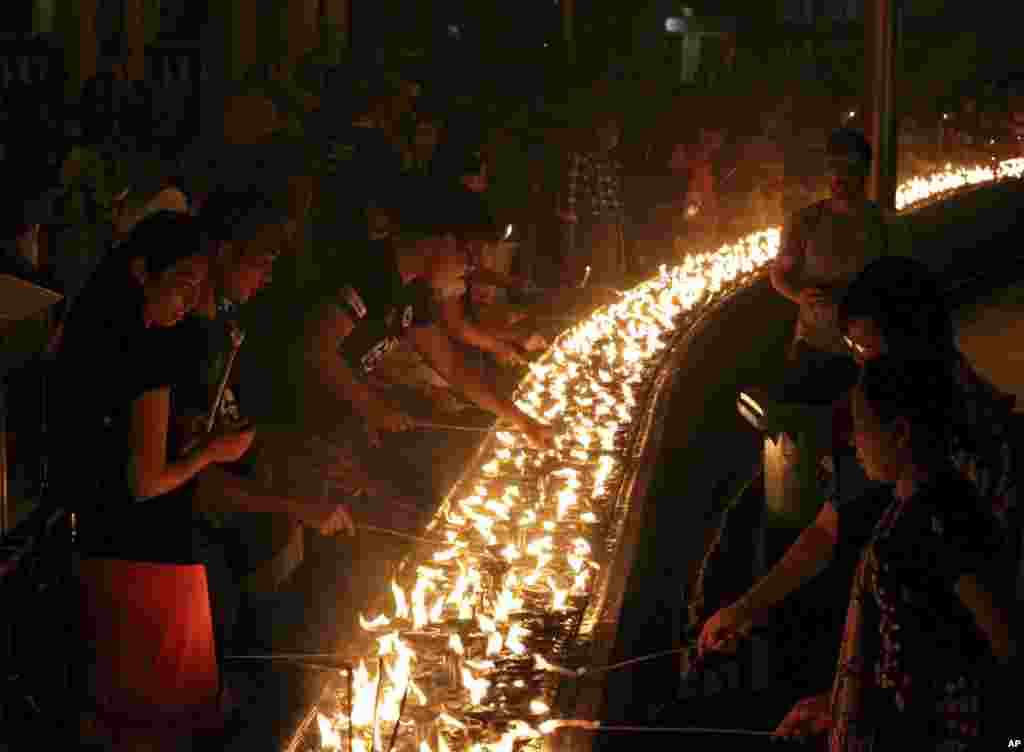 Volunteers light oil lamps during earth hour celebrations at Myanmar's famous Shwedagon pagoda, in Yangon, Myanmar, March 25, 2017. Volunteers took part in earth hour celebrations organised by World Wide Fund for Nature (WWF-Myanmar) for the first time in