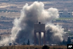 FILE - Smoke and explosions from fighting between forces loyal to Syrian President Bashar Assad and rebels in the Quneitra area of Syria are seen from the Israeli-occupied Golan Heights, June 17, 2015. The Russian military intervention to prop up the Syrian government has put new scrutiny on the CIA’s secret support to Syrian rebels fighting Bashar Assad.