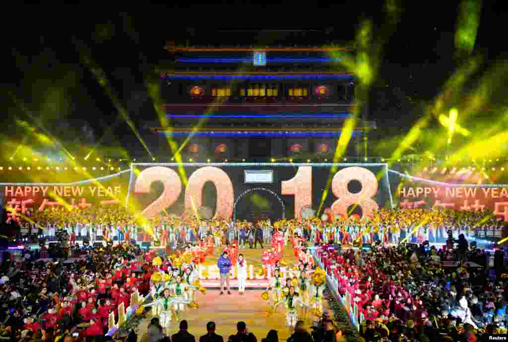 People celebrate the new year during a countdown event at Yongdingmen Gate in Beijing, China, Jan. 1, 2018. 