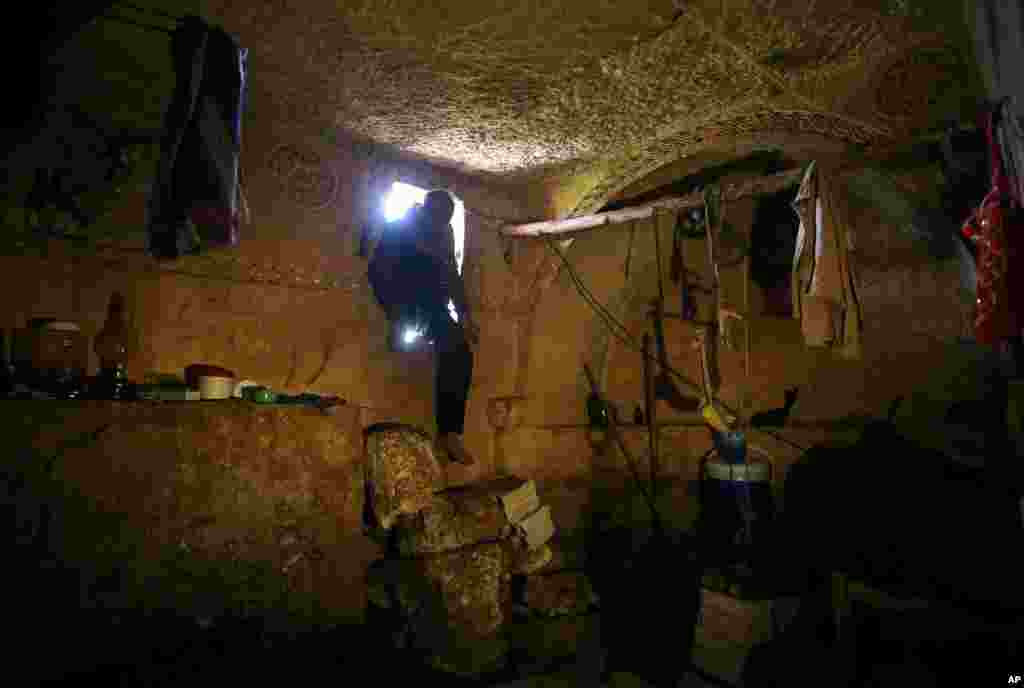 Sami, 32, steps into an underground Roman tomb used for shelter from Syrian government shelling and airstrikes, Jabal al-Zaweya, Idlib province, Syria, Feb. 28, 2013. 