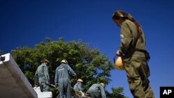 Israeli soldiers from the Home Front Command take part in a drill simulating a building collapse following a mock rocket attack at Zikim army base, near the southern city of Ashkelon, June 19, 2011