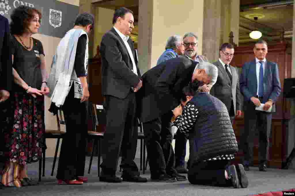 Mexico&#39;s President Andres Manuel Lopez Obrador comforts a woman asking him for help in looking for her missing family member at National Palace in Mexico City. The Mexican government identified thousands of human remains in morgues and mass graves over more than a decade of gang violence.