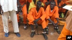 This undated photo shows prisoners sitting together at the central prison in the capital Juba, South Sudan. A new Amnesty International report accuses authorities in South Sudan of torturing people to death in detention and letting many others languish.