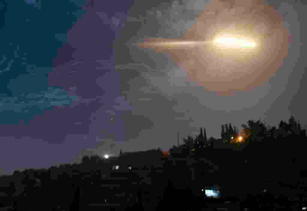 In this photo released by the Syrian official news agency SANA, shows missiles flying into the sky near international airport, in Damascus, Syria. In a very unusual move, the Israeli military has issued a statement saying it is attacking Iranian military targets in Syria. It is also warning Syrian authorities not to retaliate against Israel.