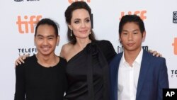 Maddox Jolie-Pitt, from left, Angelina Jolie and Pax Jolie-Pitt attend a premiere for "First They Killed My Father" on day 5 of the Toronto International Film Festival at the Princess of Wales Theatre, Sept. 11, 2017, in Toronto.