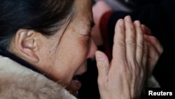 A relative of a passenger onboard Malaysia Airlines flight MH370 cries at the Beijing Capital International Airport in Beijing March 8, 2014. 