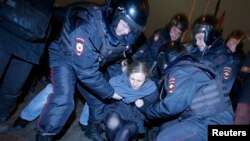 FILE - Punk protest band Pussy Riot member Maria Alyokhina is detained by police at a protest in central Moscow February 24, 2014.