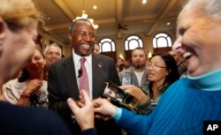 FILE - Republican presidential candidate and retired neurosurgeon Ben Carson meets with voters during campaign stop at the University of New Hampshire, Durham, Sept. 30, 2015.