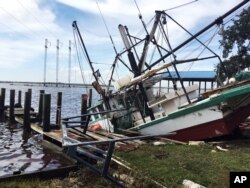 A shrimp boat is sunk at its mooring along the Pascagoula River in Moss Point, Mississippi, Oct. 8, 2017, after Hurricane Nate made landfall on Mississippi's Gulf Coast.
