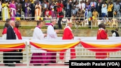 Pope Francis walks across a bridge toward the pulpit to celebrate Mass, in Namugongo, Uganda, Nov. 28, 2015.