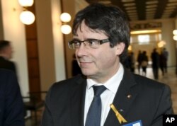FILE - Carles Puigdemont, deposed leader of a Catalonian pro-independence party, visits the Finnish Parliament in Helsinki, March 22, 2018.