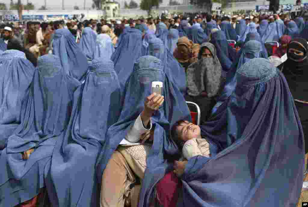 Supporters of Afghan presidential candidate Abdullah Abdullah listen to his speech during a campaign rally in Jalalabad.