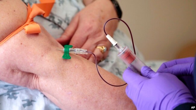 FILE - A patient has her blood drawn at a hospital in Philadelphia to monitor her cancer treatment, April 28, 2015.