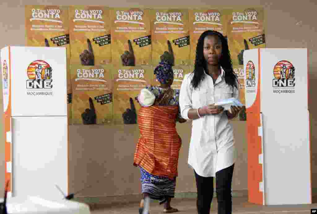 A voter waits in line, prepared to cast a vote at a polling station in Maputo. 