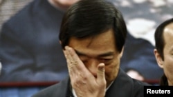 China's former Chongqing Municipality Communist Party Secretary Bo Xilai wipes tears at a public mourning his father Bo Yibo, also a former top communist party official, in Beijing on January 17, 2007. 